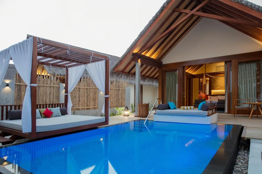 Tropical beach villa with pool, cabana, and island resort exterior
